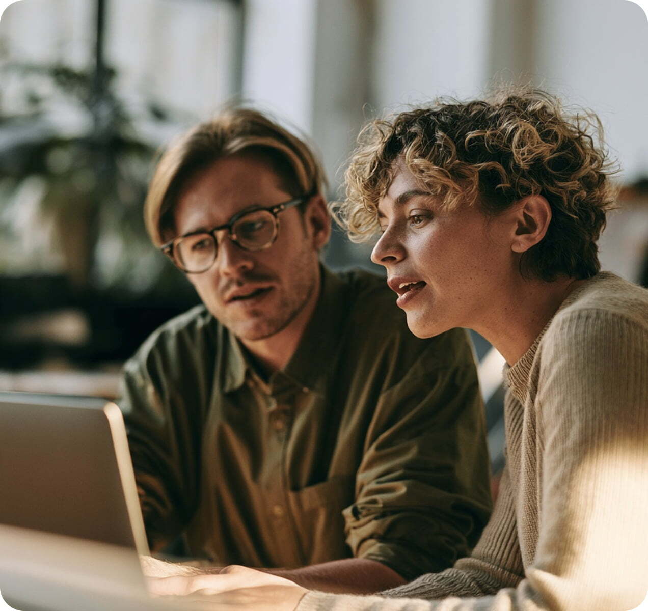 Two colleagues working together on a laptop