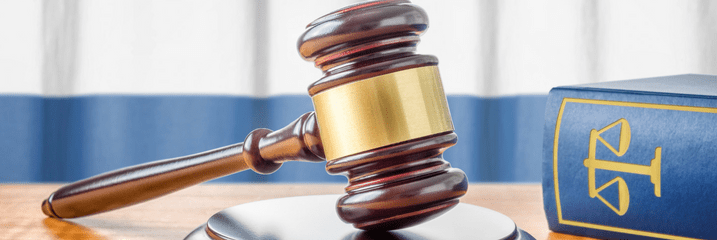 Gavel beside legal book