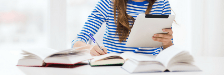 woman with books and tablet