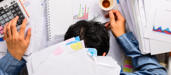 man buried in papers