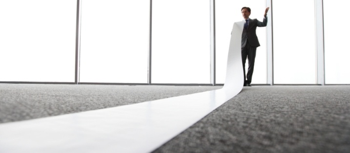 man unrolling paper