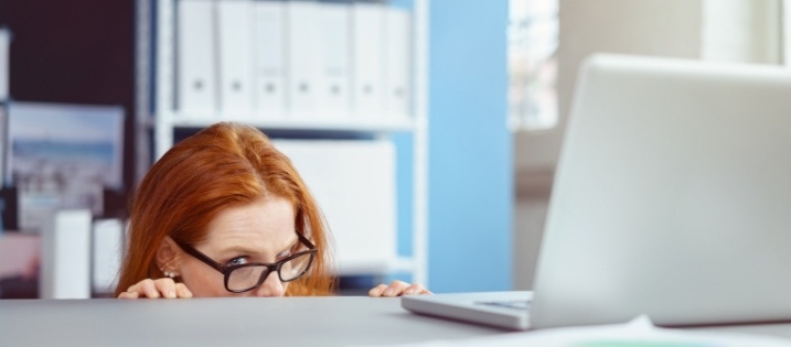 woman peeking over desk